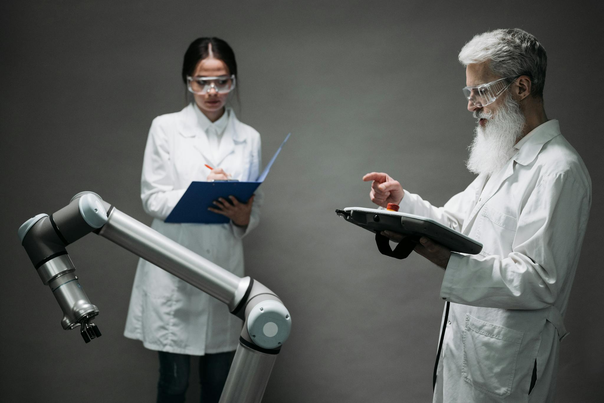 Scientists in a lab working with a robot, focusing on technological innovation and development.